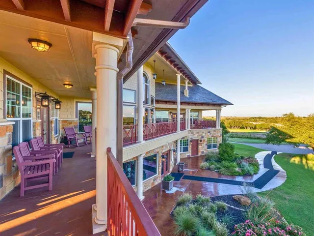 a view of an house with roof deck and seating space