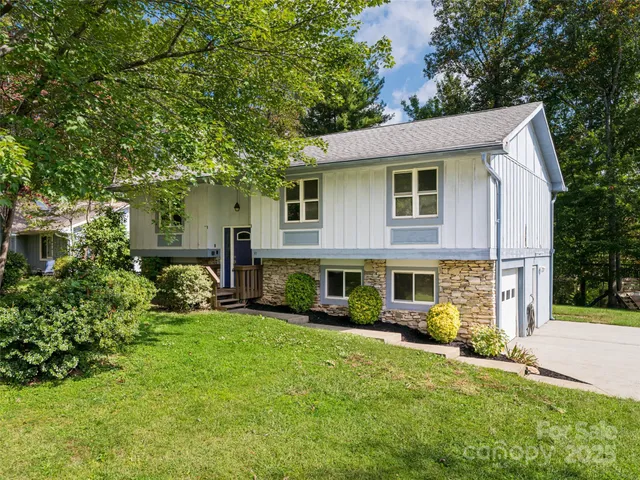 a view of a house with a yard patio and a garden