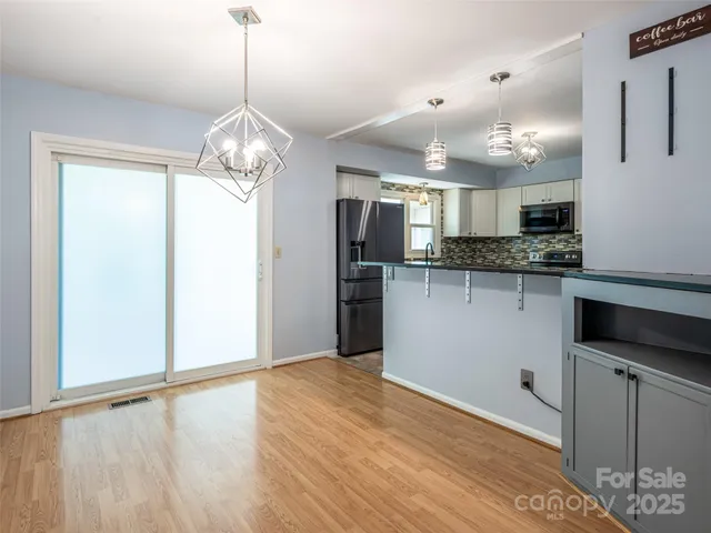 a view of a kitchen with a sink and stainless steel appliances