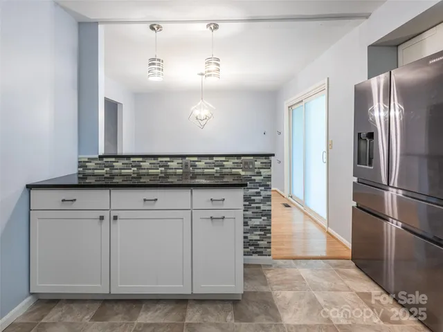 a kitchen with stainless steel appliances granite countertop a refrigerator and a sink