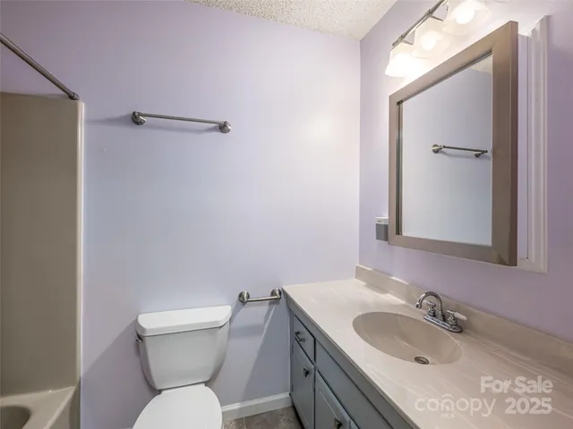 a bathroom with a sink toilet and mirror