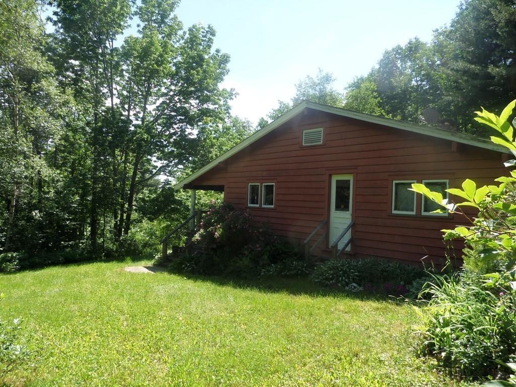 9 Bell Road Middlefield, MA 01243 - Photo 5 of 18 a view of a backyard with plants and large trees