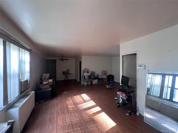 a view of a livingroom with furniture and a large window