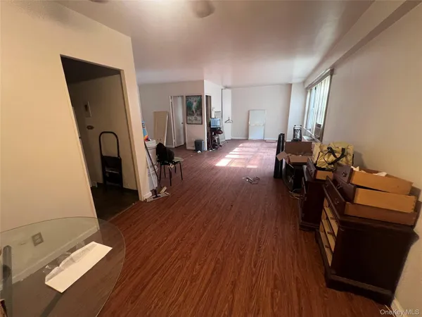 a view of a workspace with furniture and wooden floor