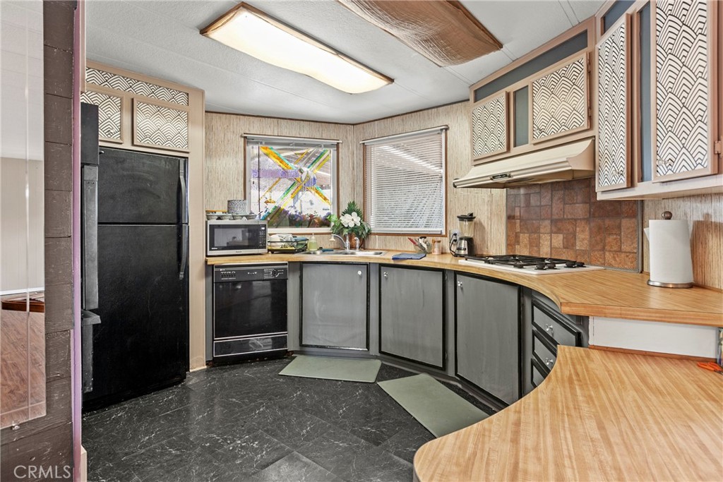 519 West Taylor Street, Unit 252 Santa Maria, CA 93458 - Photo 19 of 52 a kitchen with stainless steel appliances granite countertop a refrigerator a sink dishwasher a stove with white cabinets and countertops