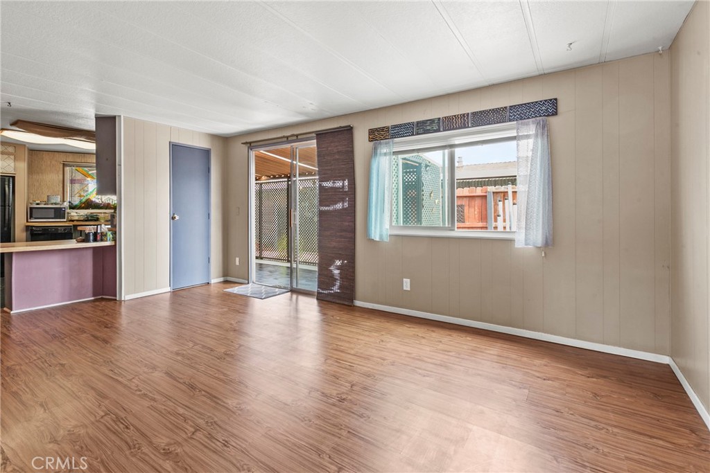 519 West Taylor Street, Unit 252 Santa Maria, CA 93458 - Photo 22 of 52 an empty room with wooden floor and windows
