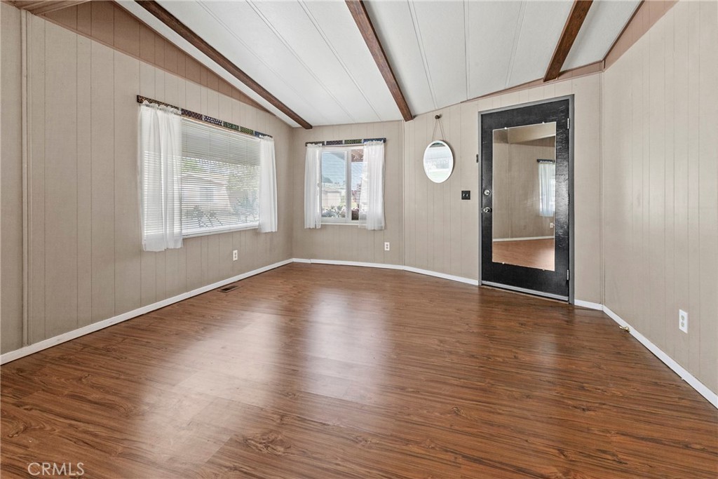 519 West Taylor Street, Unit 252 Santa Maria, CA 93458 - Photo 27 of 52 a view of an empty room with wooden floor and a window