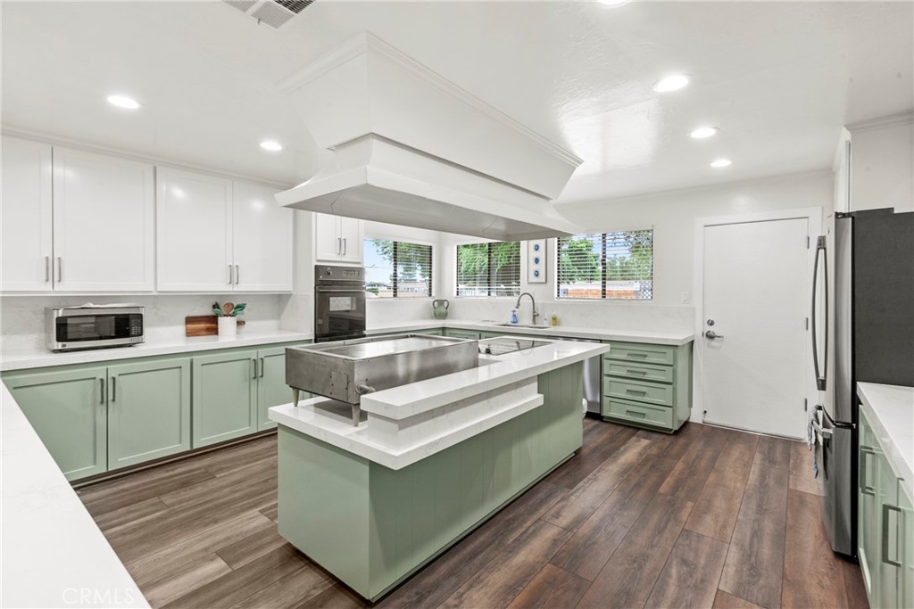 519 West Taylor Street, Unit 252 Santa Maria, CA 93458 - Photo 31 of 52 a kitchen with stainless steel appliances white cabinets a sink a stove a refrigerator and island
