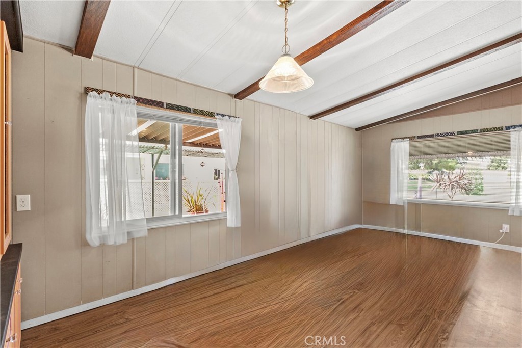 519 West Taylor Street, Unit 252 Santa Maria, CA 93458 - Photo 7 of 52 an empty room with wooden floor and windows