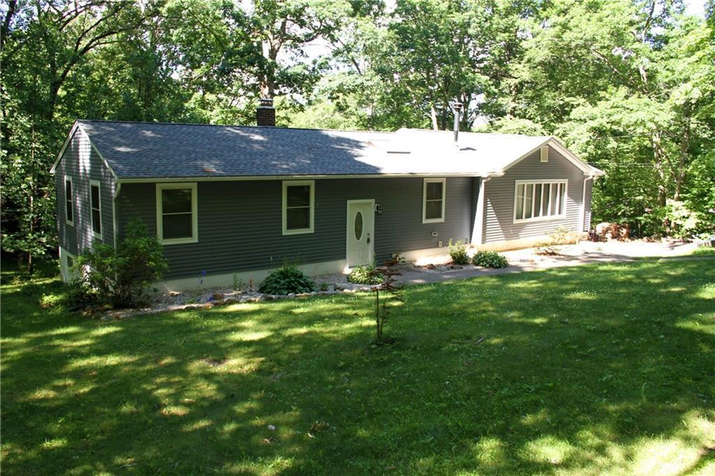 a front view of house with yard and green space