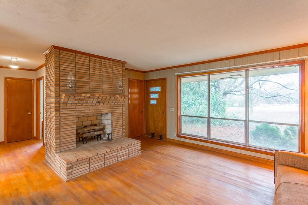 0 Tibbs Bridge Road Southeast Dalton, GA 30721 - Photo 3 of 22 a living room with fireplace furniture and a large window