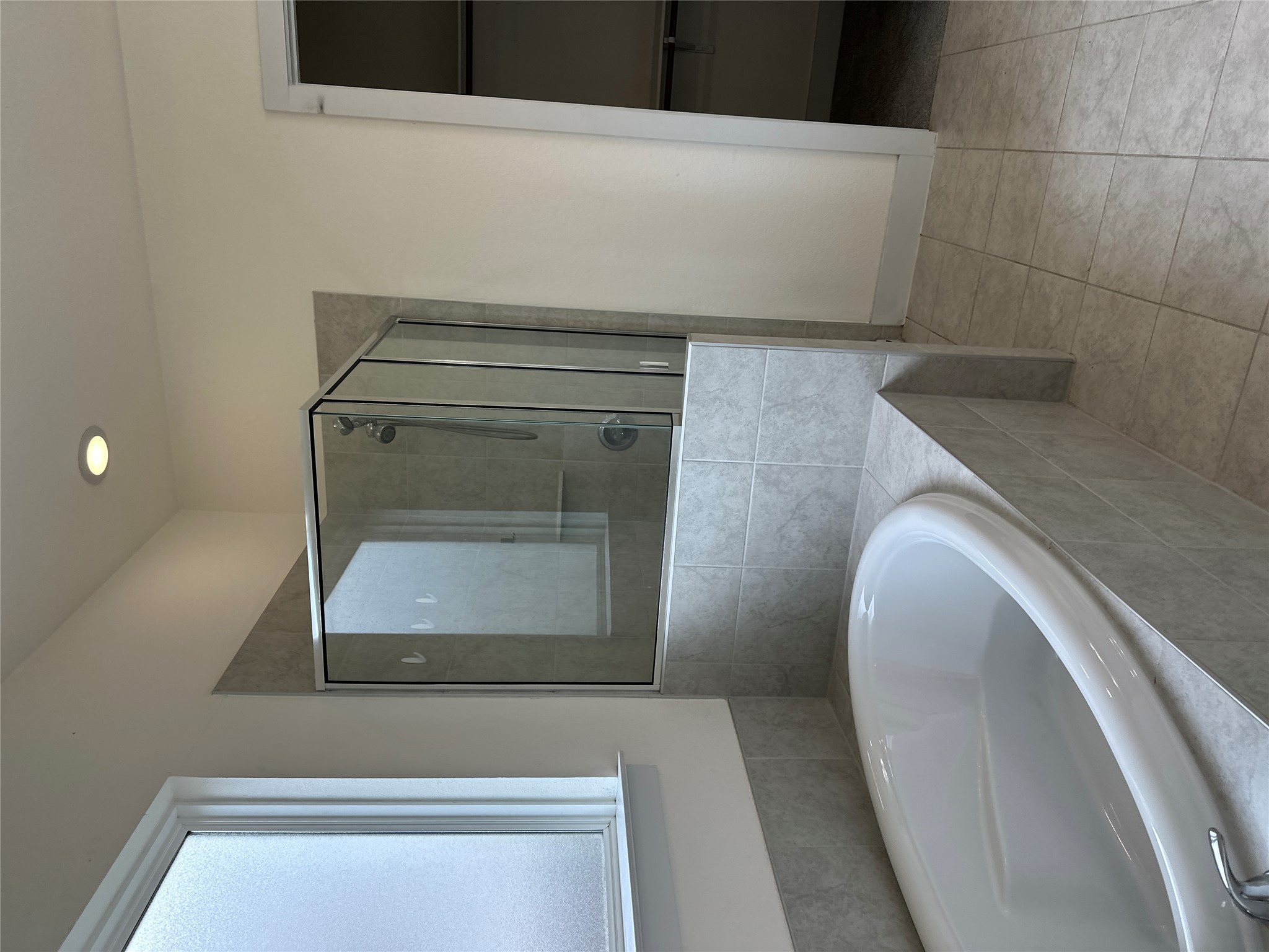 11204 Charger Way Manor, TX 78653 - Photo 12 of 21 a bathroom with a bathtub and a shower