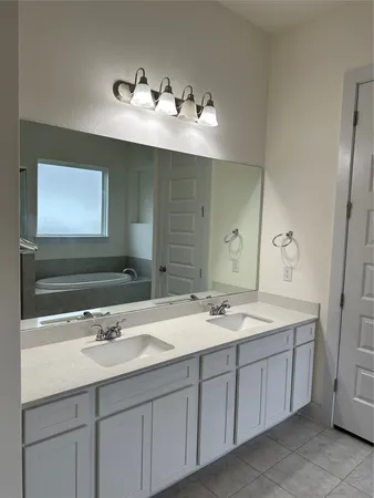 a bathroom with a tub shower and closet