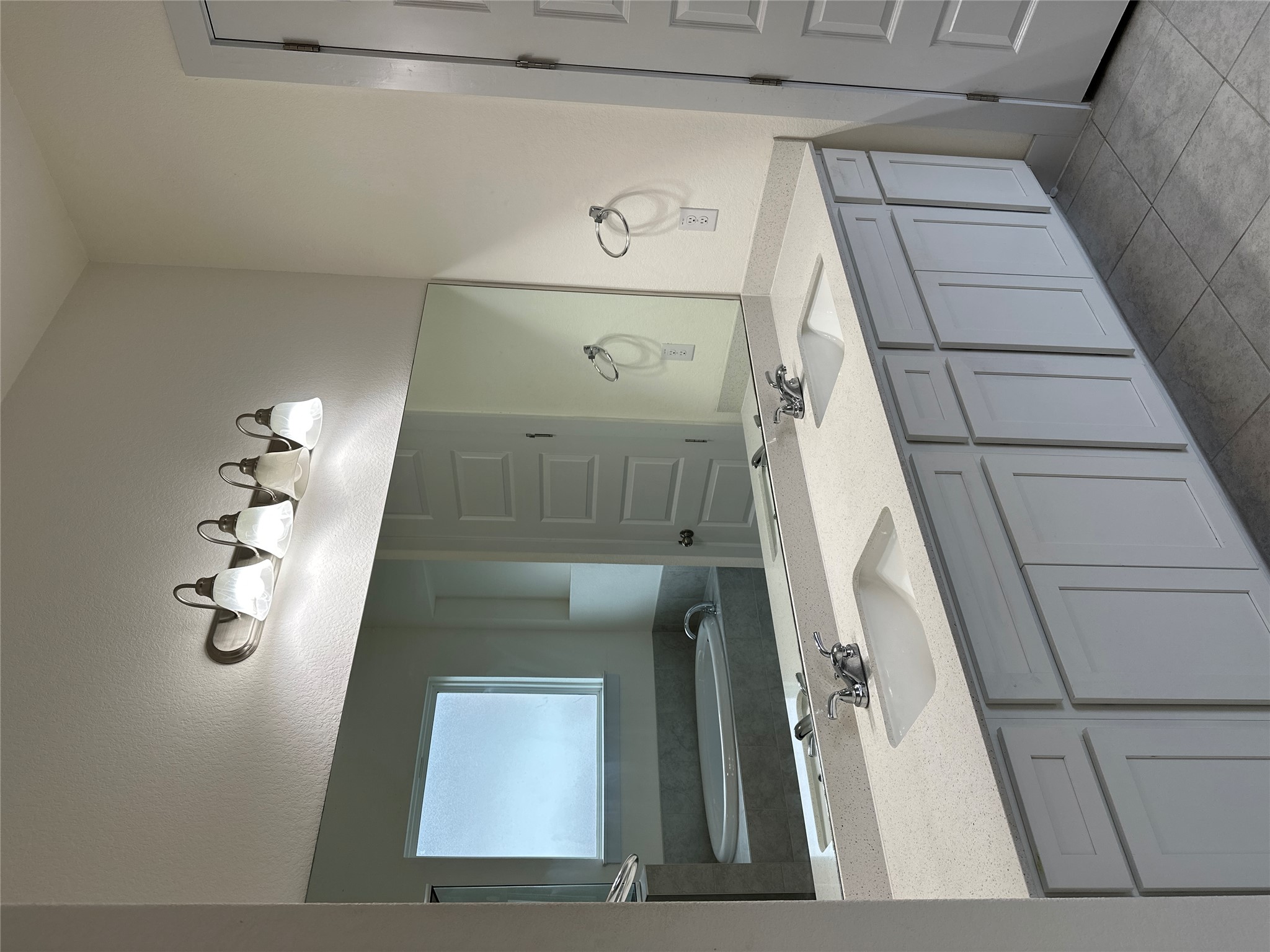 11204 Charger Way Manor, TX 78653 - Photo 13 of 21 a bathroom with a double vanity sink and mirror