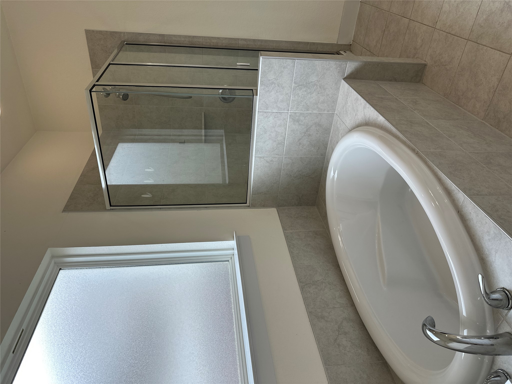 11204 Charger Way Manor, TX 78653 - Photo 16 of 21 a bath tub sitting in a bathroom and mirror