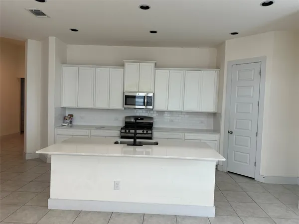 a view of kitchen with white cabinets