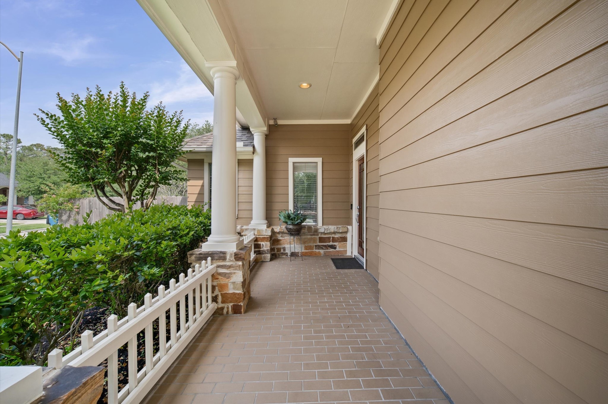 1603 Claytons Bend Court Spring, TX 77386 - Photo 35 of 38 This inviting front porch features a covered entry with elegant columns, brick flooring, and tasteful landscaping, offering a warm welcome to the home.