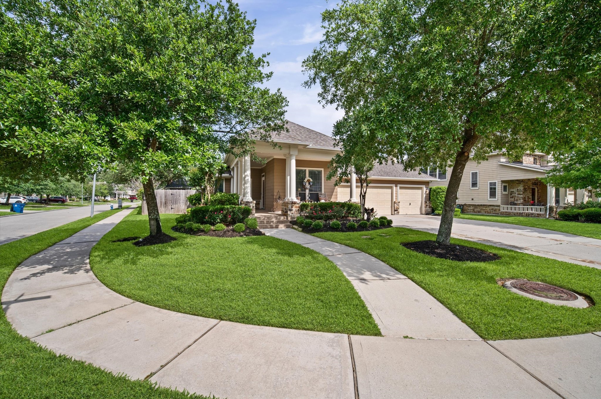 1603 Claytons Bend Court Spring, TX 77386 - Photo 4 of 38 Charming single-story home with a welcoming front porch, nestled in a beautifully landscaped yard. Features a curved driveway and mature trees, offering both curb appeal and shade.