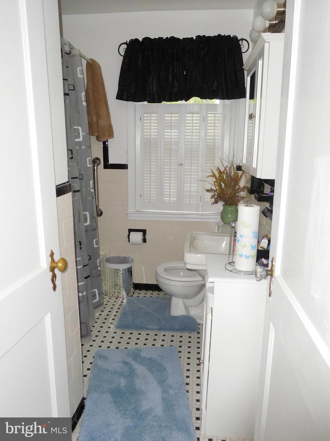1651 Northbourne Road Baltimore, MD 21239 - Photo 12 of 30 a bathroom with a sink toilet and shower