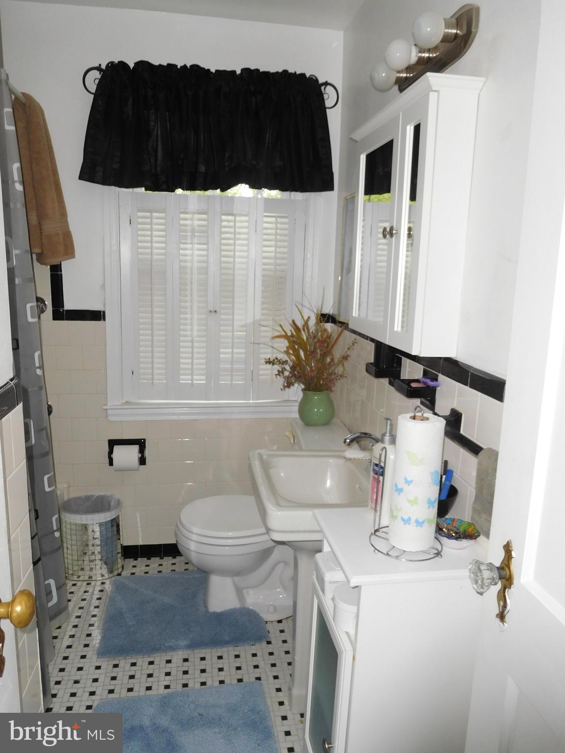 1651 Northbourne Road Baltimore, MD 21239 - Photo 13 of 30 a bathroom with a sink toilet and shower