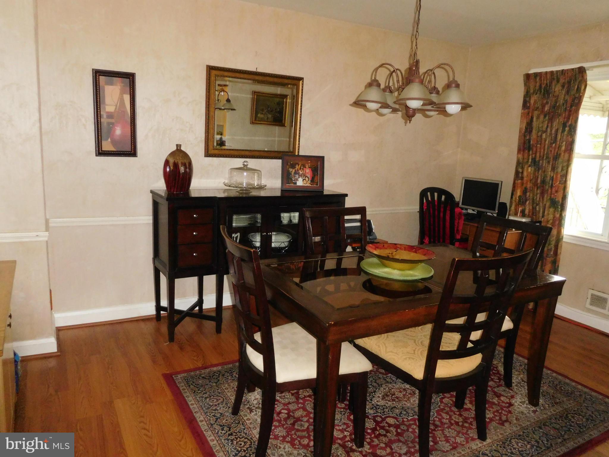 1651 Northbourne Road Baltimore, MD 21239 - Photo 16 of 30 a view of a dining room with furniture and wooden floor
