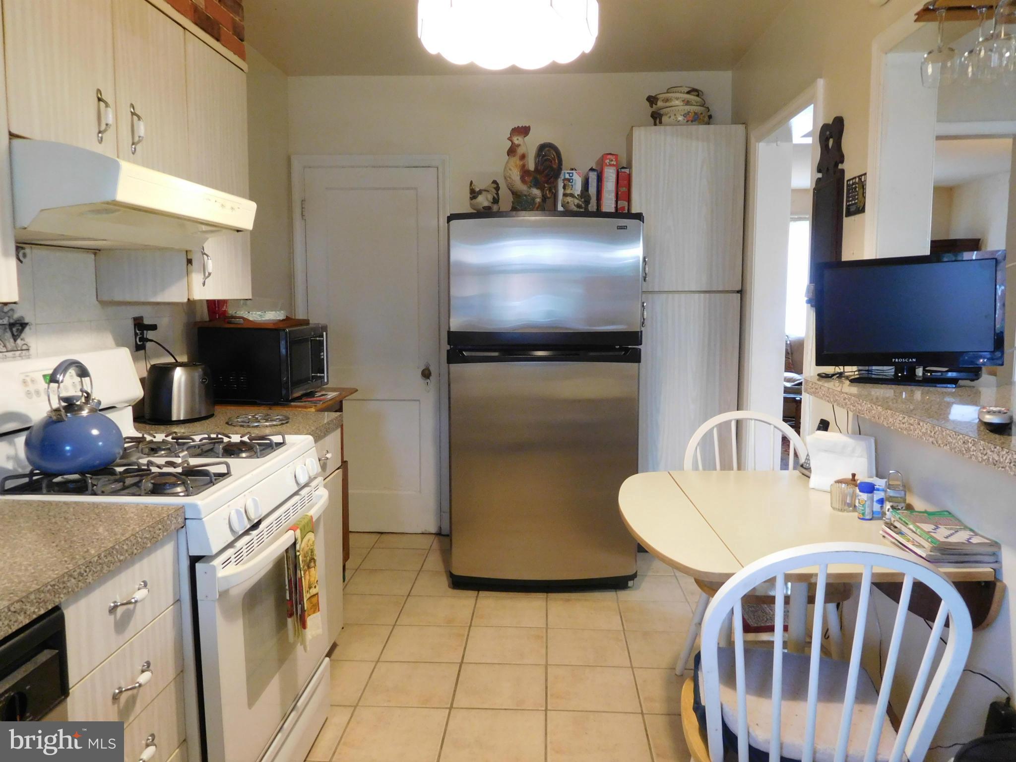 1651 Northbourne Road Baltimore, MD 21239 - Photo 21 of 30 a kitchen with stainless steel appliances granite countertop a sink a stove a refrigerator a washer and dryer