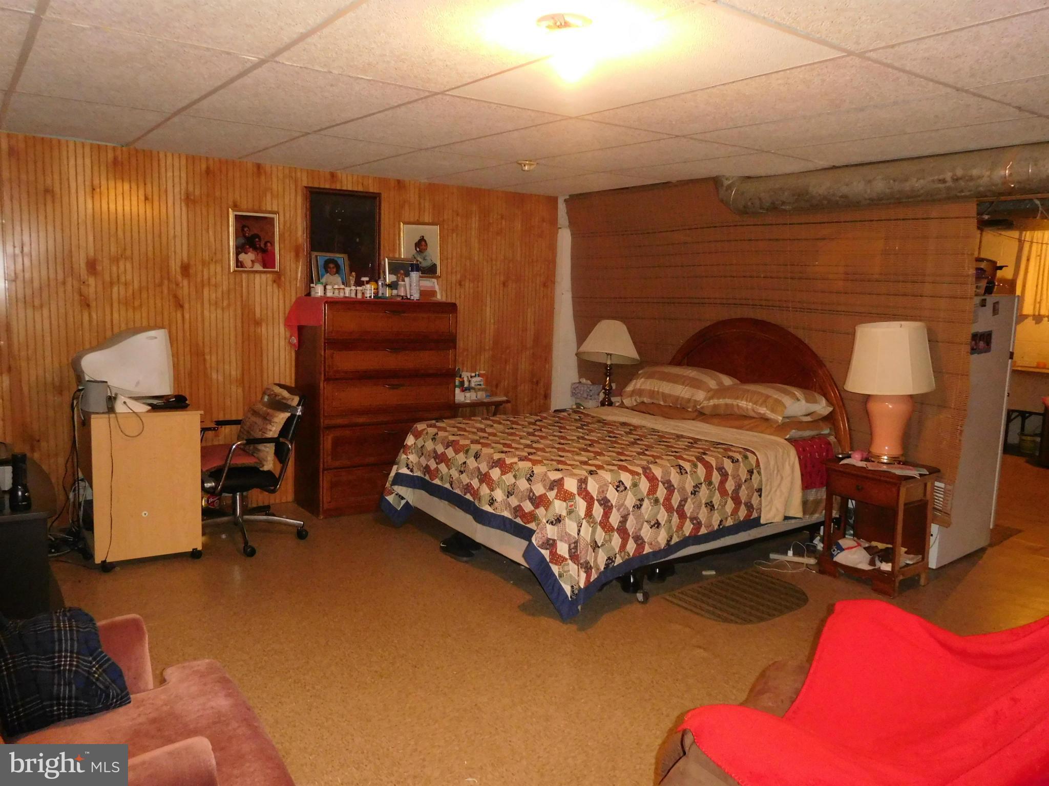 1651 Northbourne Road Baltimore, MD 21239 - Photo 23 of 30 a bedroom with a bed and wooden floor
