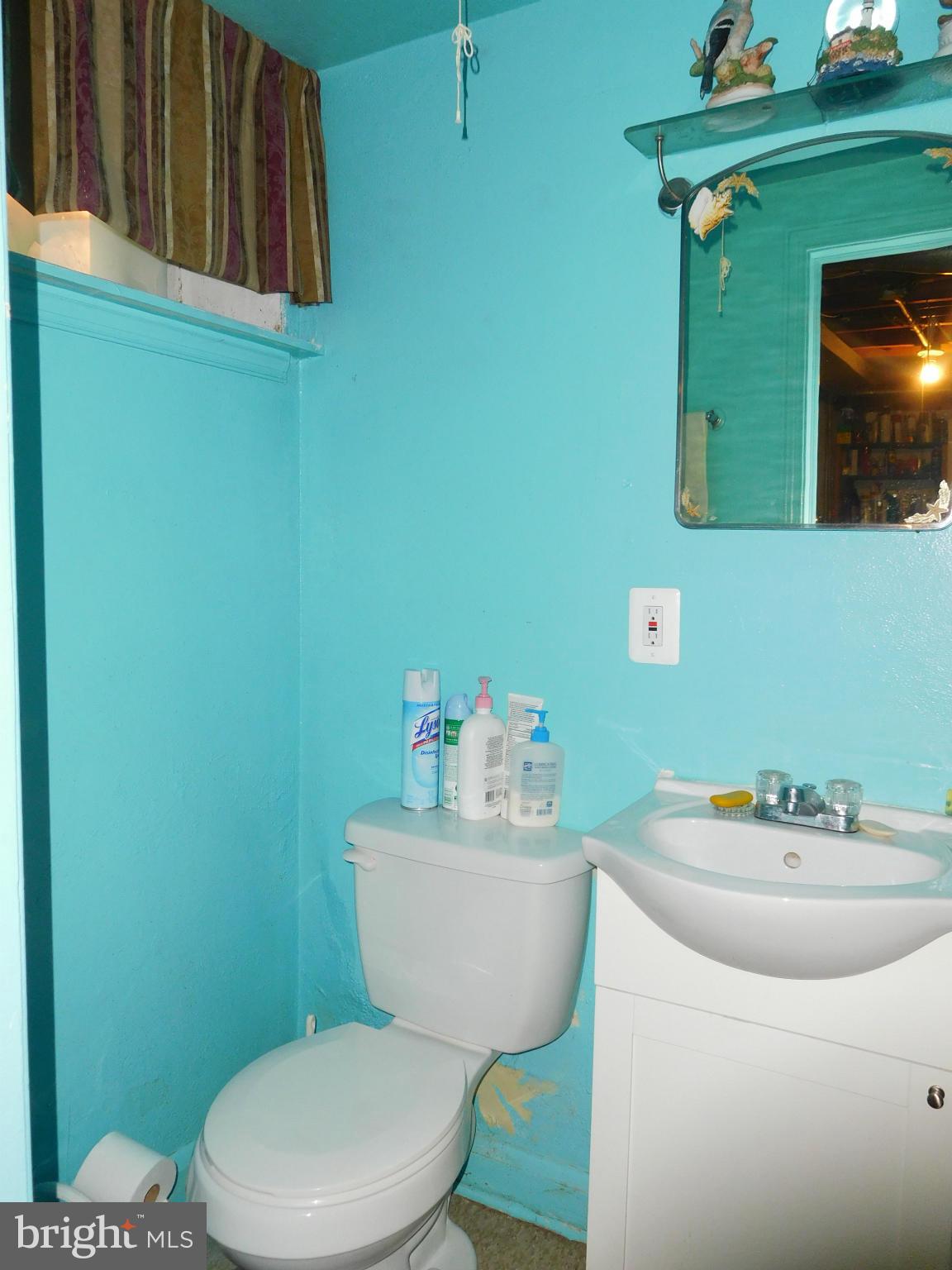 1651 Northbourne Road Baltimore, MD 21239 - Photo 27 of 30 a bathroom with a sink mirror and toilet