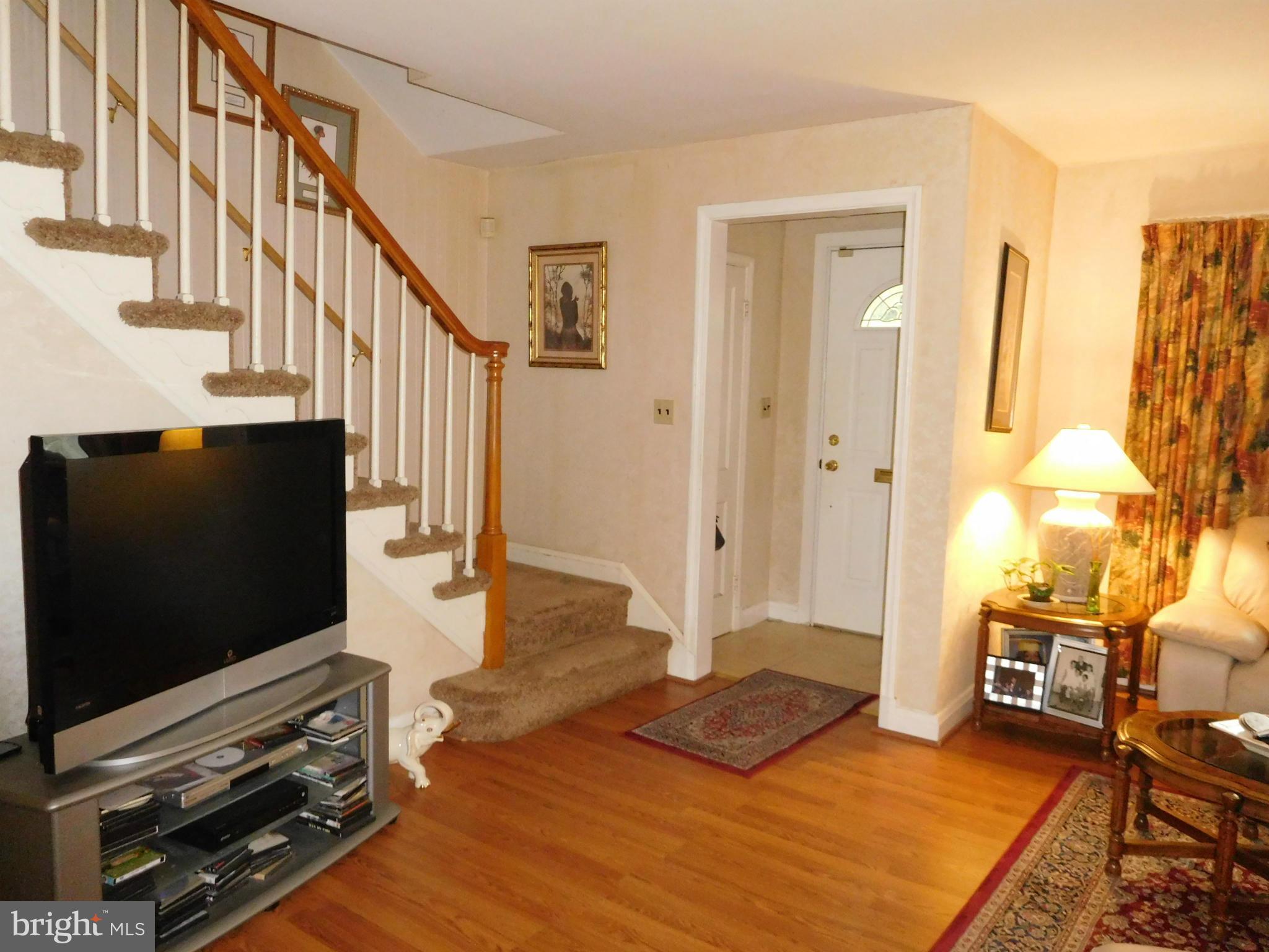 1651 Northbourne Road Baltimore, MD 21239 - Photo 6 of 30 a livingroom with wooden floor and a flat screen tv