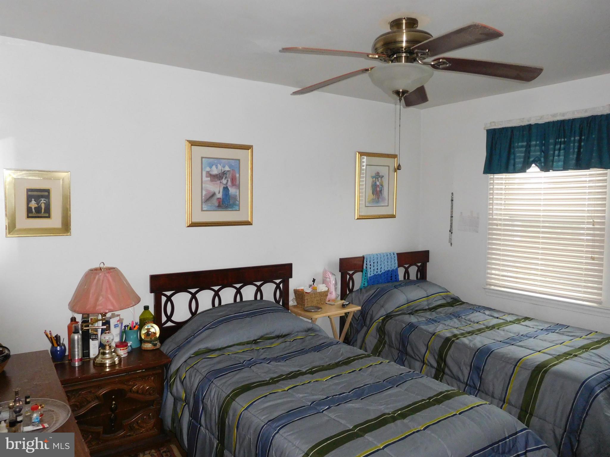 1651 Northbourne Road Baltimore, MD 21239 - Photo 8 of 30 a bedroom with two beds and a chandelier