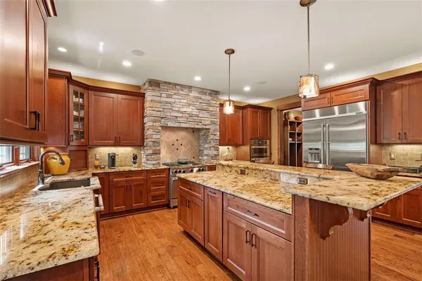 a kitchen with lots of counter space a sink and chairs