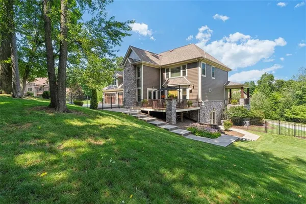 an aerial view of residential house with outdoor space and swimming pool
