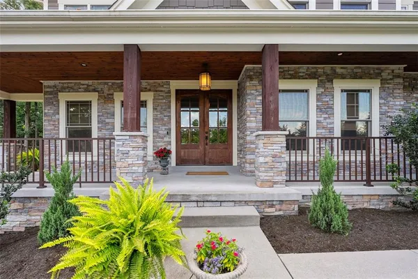 a view of an entryway with wooden floor and a chandelier