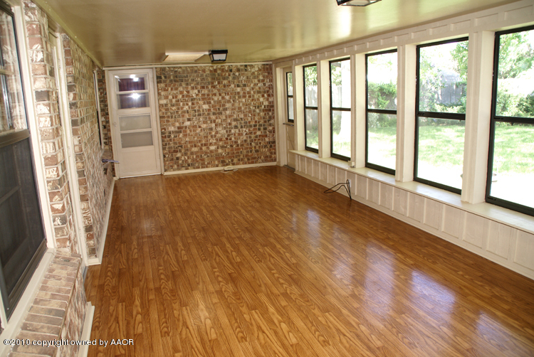 6117 Calumet Road Amarillo, TX 79106 - Photo 13 of 16 a view of an empty room with wooden floor and a window