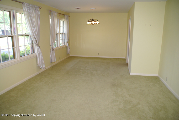 6117 Calumet Road Amarillo, TX 79106 - Photo 4 of 16 a view of an empty room with a window