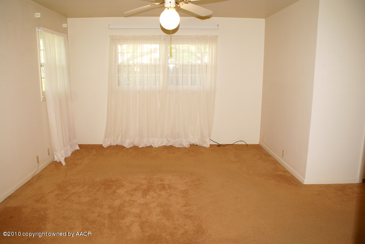 6117 Calumet Road Amarillo, TX 79106 - Photo 7 of 16 a view of a bedroom with a window