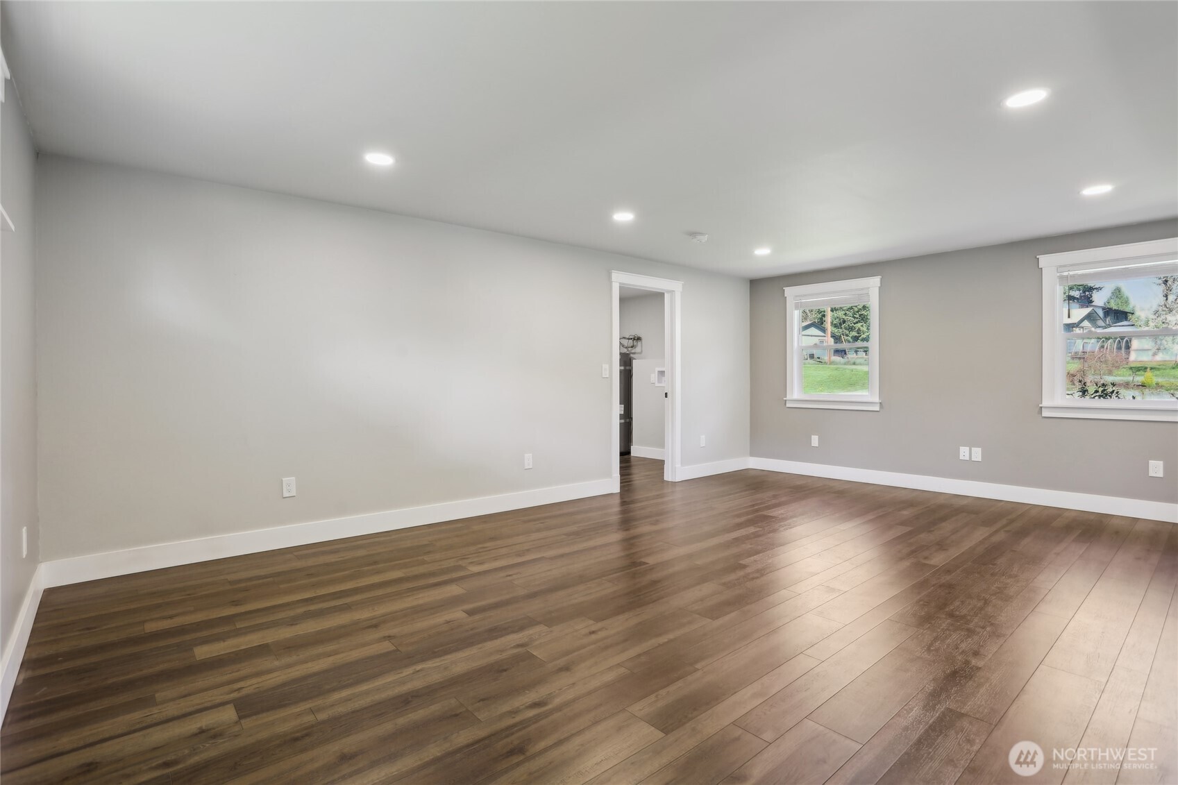 27713 Webster Road East Graham, WA 98338 - Photo 21 of 39 a view of an empty room with wooden floor and a window