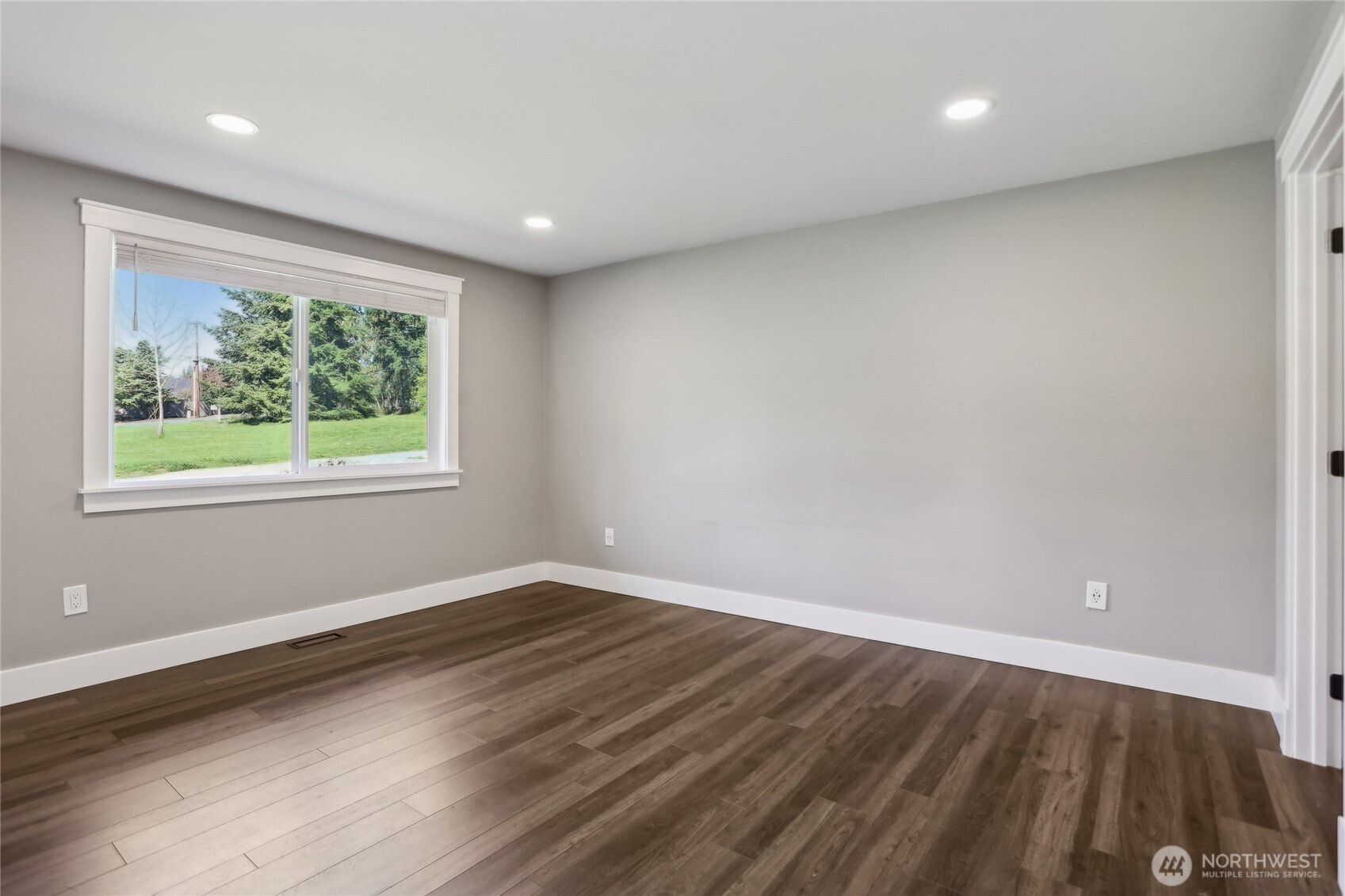 27713 Webster Road East Graham, WA 98338 - Photo 23 of 39 an empty room with wooden floor and windows