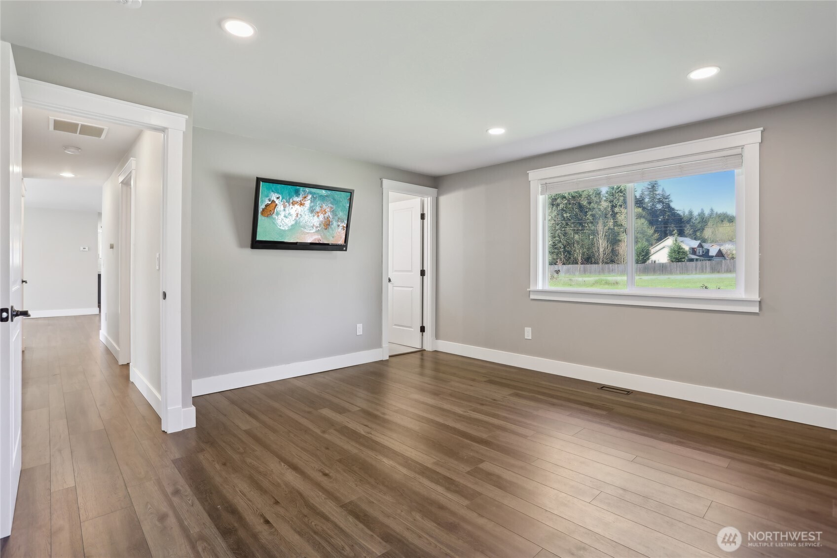 27713 Webster Road East Graham, WA 98338 - Photo 25 of 39 a view of an empty room with wooden floor and a window