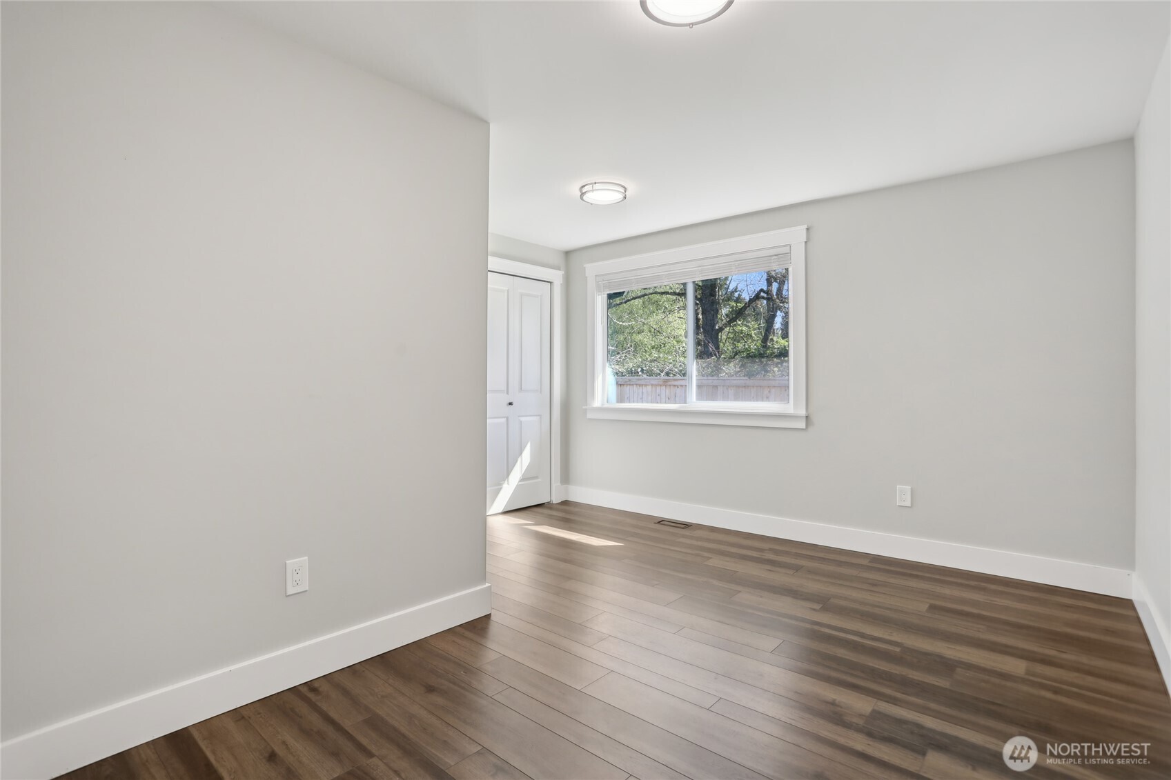 27713 Webster Road East Graham, WA 98338 - Photo 28 of 39 an empty room with wooden floor and windows