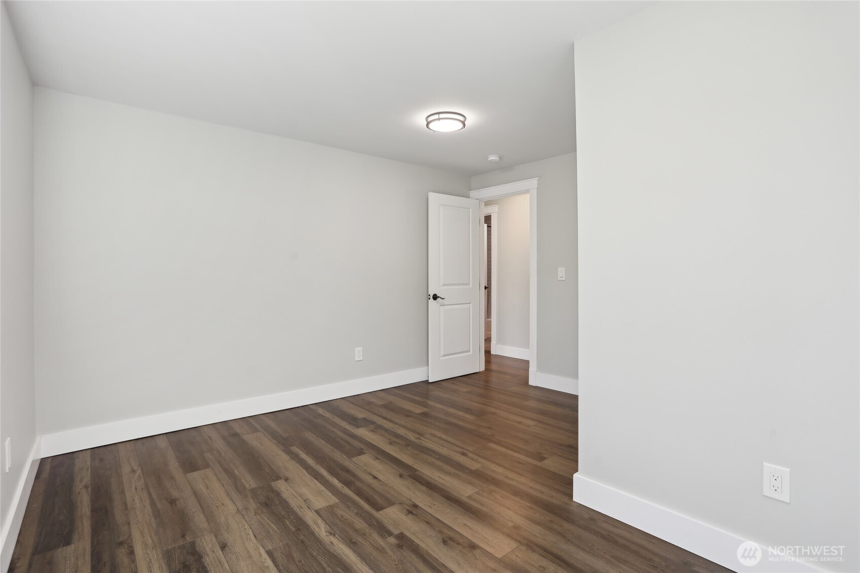 27713 Webster Road East Graham, WA 98338 - Photo 29 of 39 a view of an empty room with wooden floor