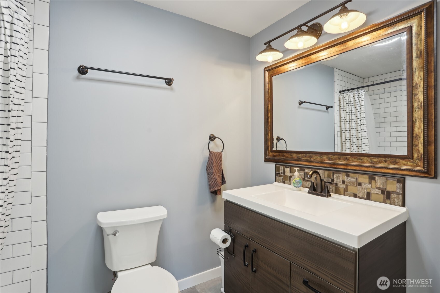 27713 Webster Road East Graham, WA 98338 - Photo 30 of 39 a bathroom with a toilet sink and mirror
