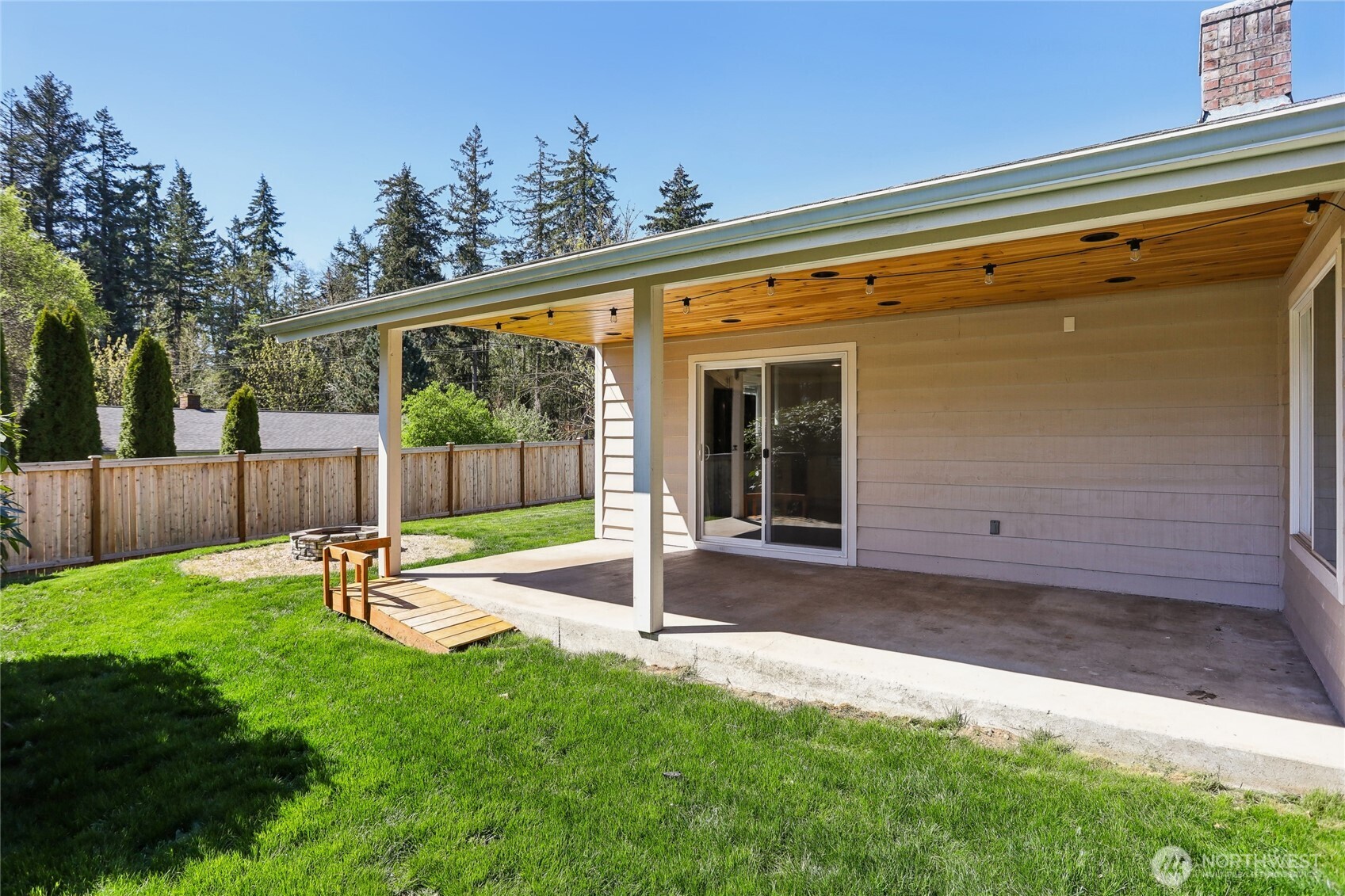 27713 Webster Road East Graham, WA 98338 - Photo 35 of 39 a view of a chair and table in backyard of the house