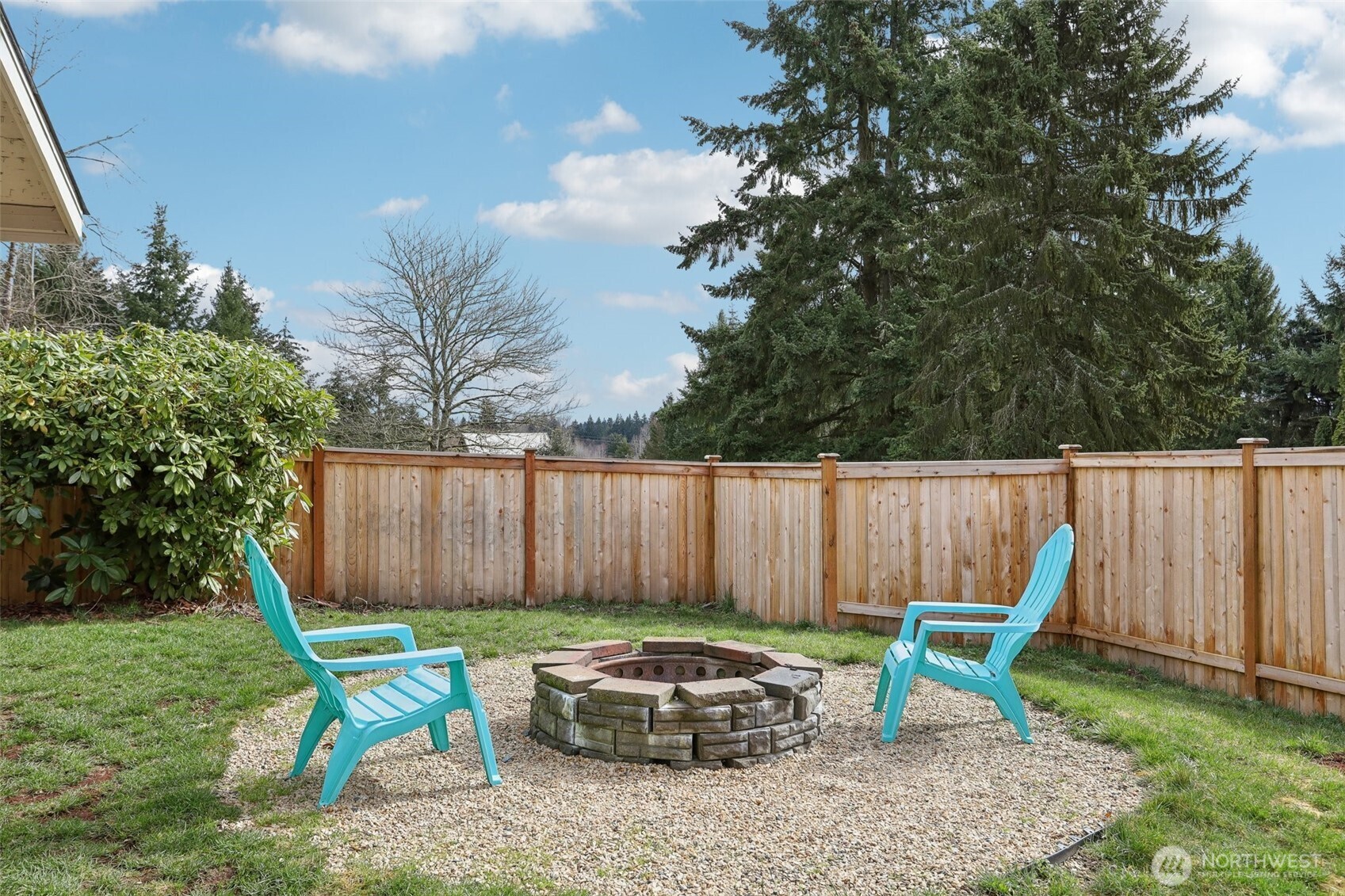 27713 Webster Road East Graham, WA 98338 - Photo 36 of 39 a backyard of a house with table and chairs