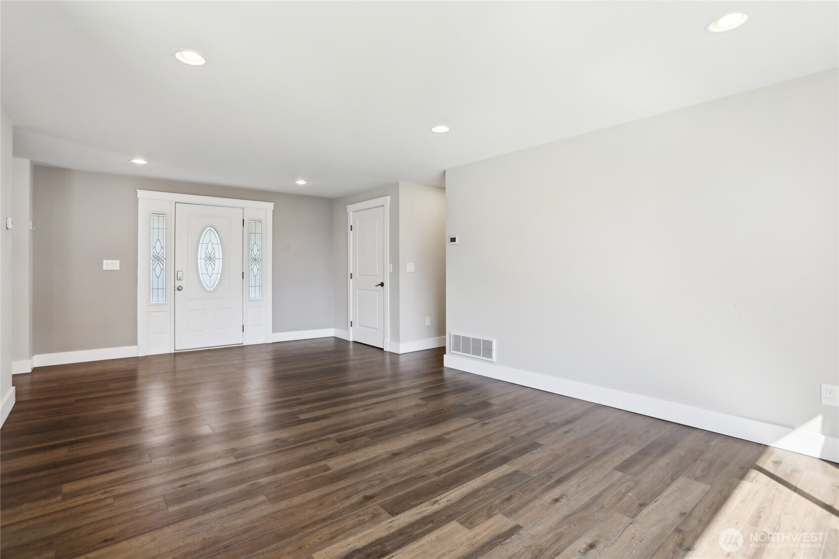 27713 Webster Road East Graham, WA 98338 - Photo 9 of 39 a view of an empty room with wooden floor
