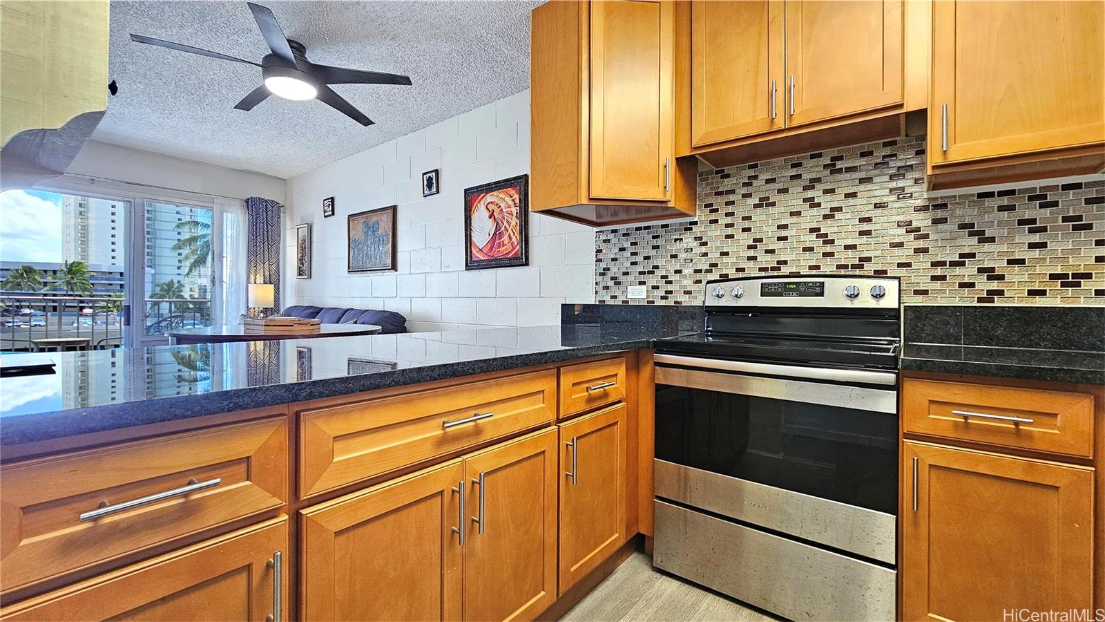 955 Ala Lilikoi Street, Unit 502 Honolulu, HI 96818 - Photo 5 of 21 a kitchen with stainless steel appliances a stove and a refrigerator