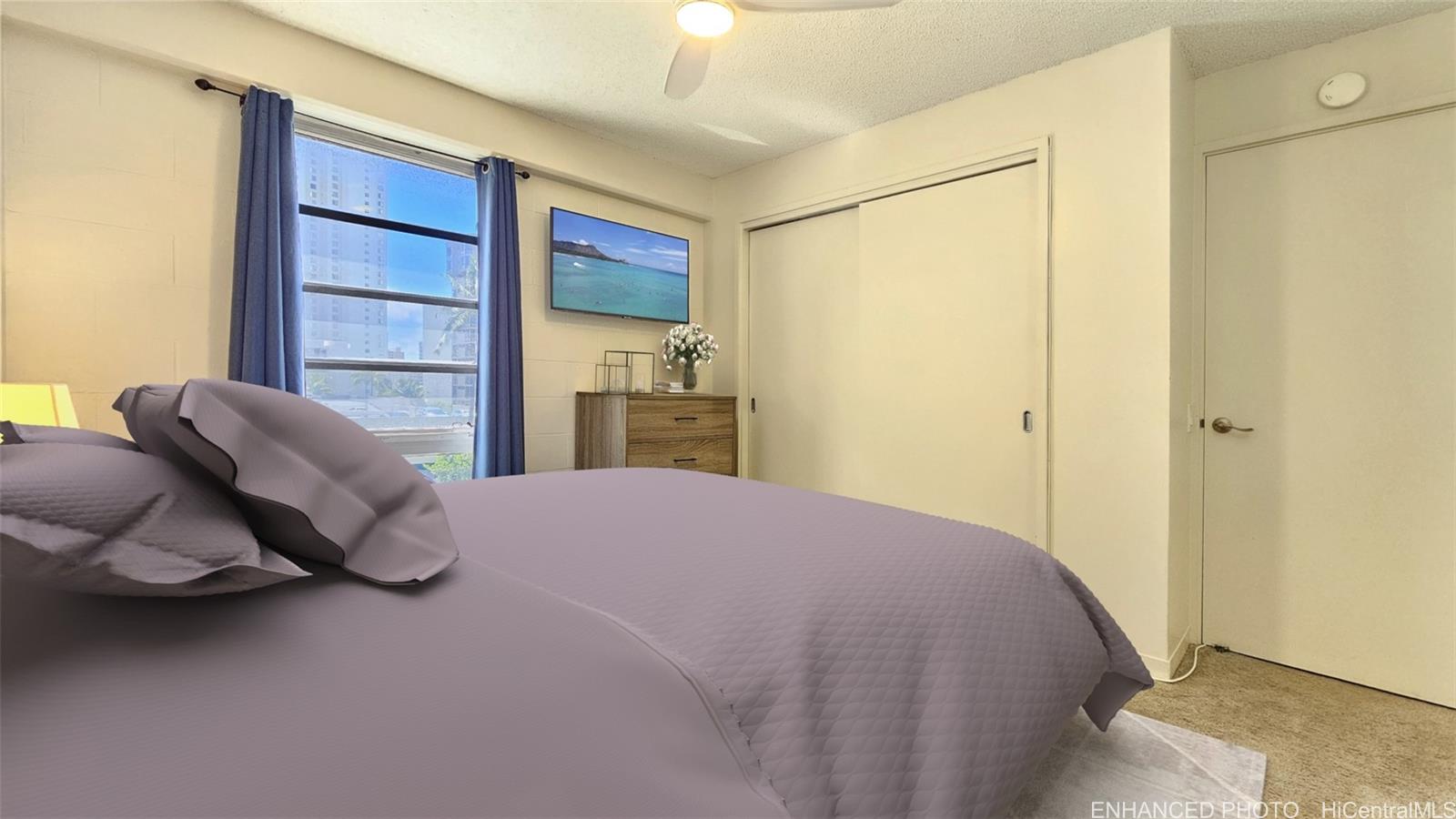 955 Ala Lilikoi Street, Unit 502 Honolulu, HI 96818 - Photo 8 of 21 a bedroom with a bed and a window