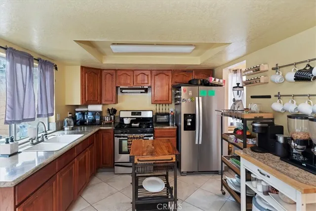 a kitchen with stainless steel appliances a refrigerator sink and stove