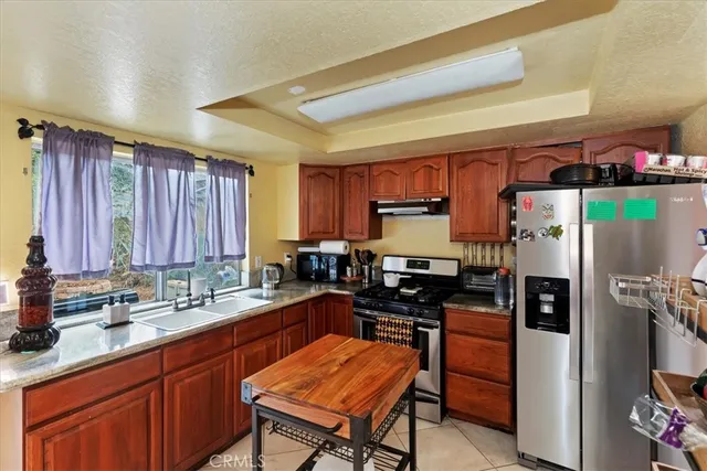 a kitchen with a sink appliances and cabinets