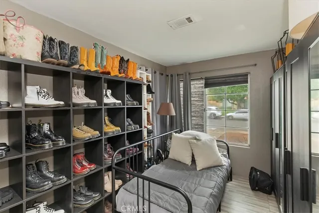 a living room with furniture cabinets and a window